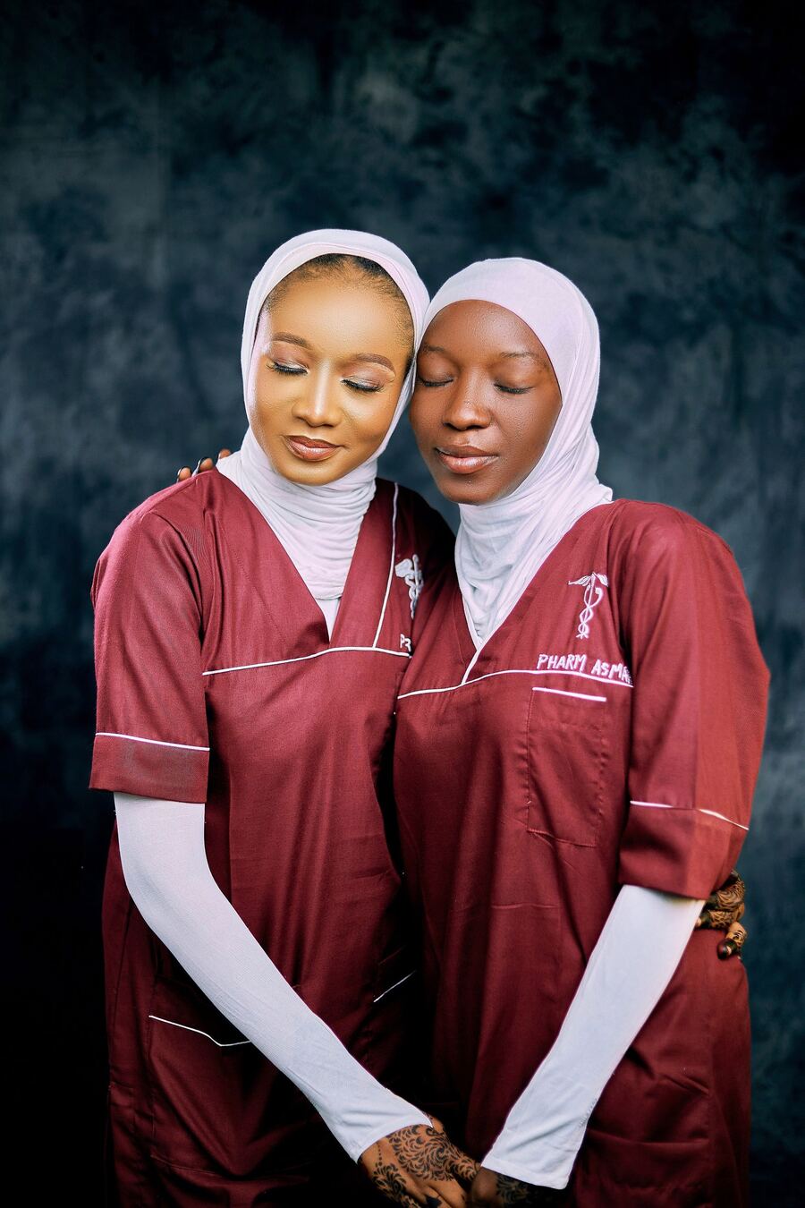 Two care workers in uniform, smiling